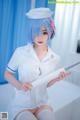 A woman in a nurse outfit holding a knife.