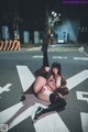 A woman laying on the ground in the middle of a street.