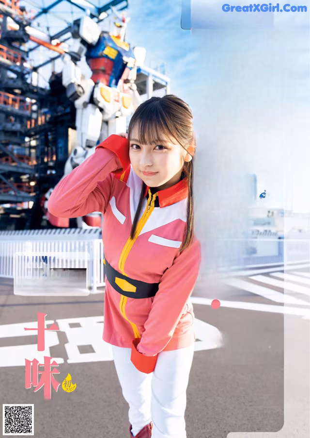 A woman in a pink jacket and white pants posing for a magazine.