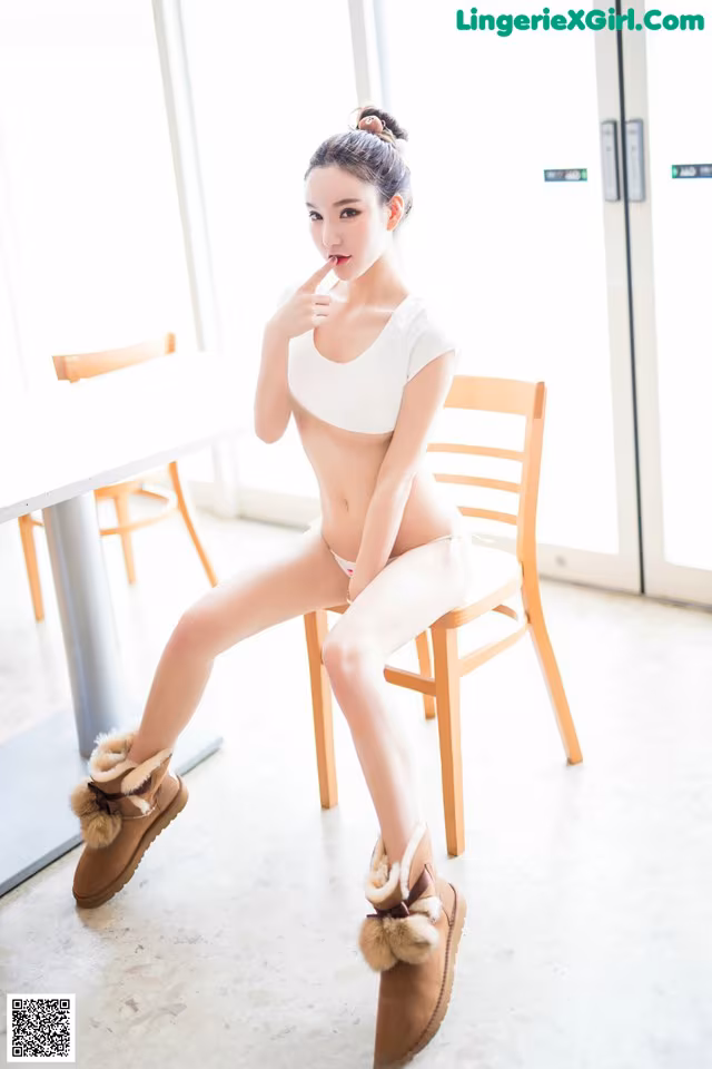 A woman sitting on a chair in a room.