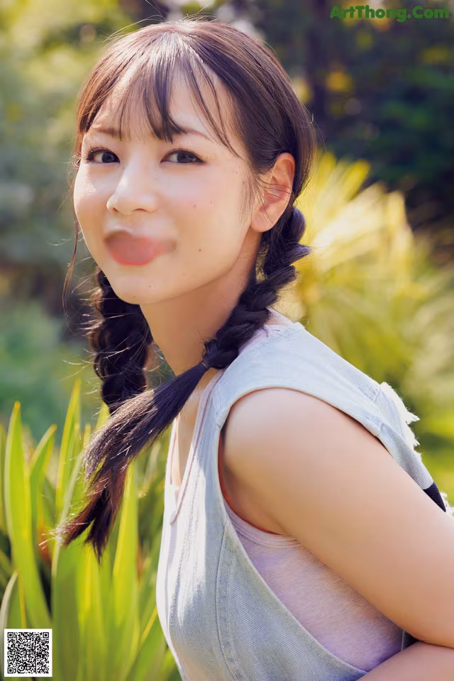 A young woman with long black hair smiling at the camera.