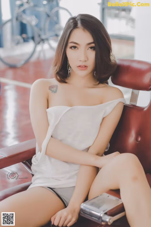 a woman sitting on top of a red chair