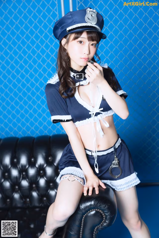 A woman dressed as a police officer sitting on a couch.